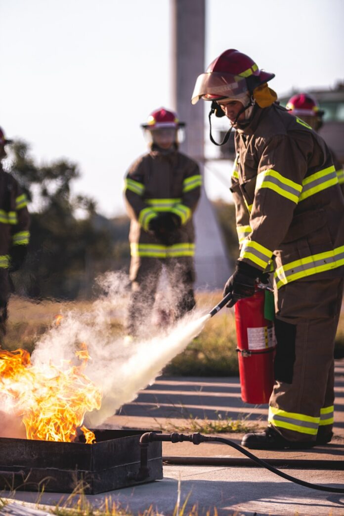 Photo by Chandler Cruttenden a group of firefighters standing around a fire hydrant