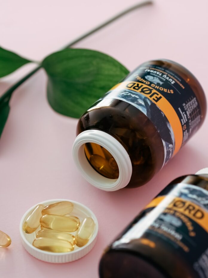 Photo by Natallia Photo a close up of a bottle of pills next to a plant