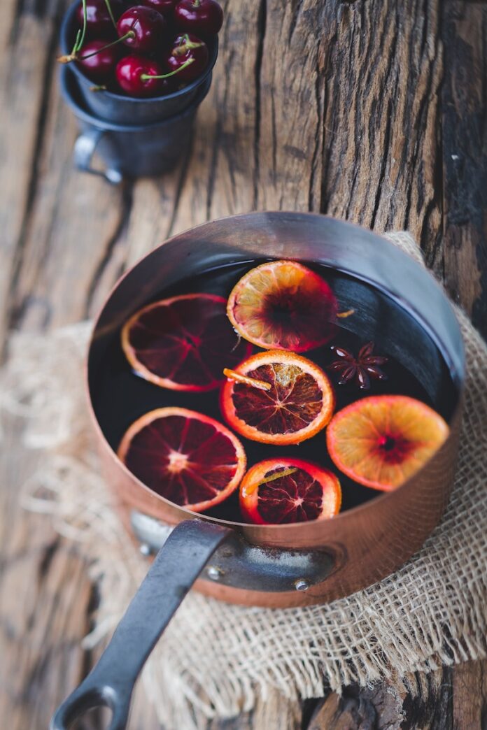Photo by Hannah Pemberton close-up photography of sliced orange fruit on brown cooking pot
