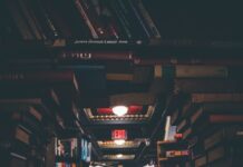 뇌 건강을 지키는 습관, 치매 예방의 첫걸음 view of floating open book from stacked books in library