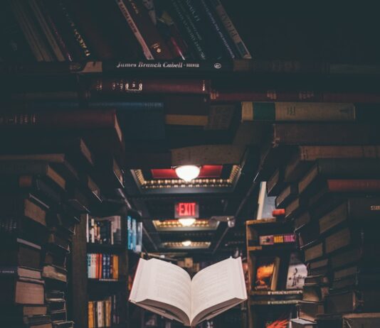 뇌 건강을 지키는 습관, 치매 예방의 첫걸음 view of floating open book from stacked books in library