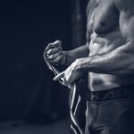 “내게 딱 맞는 근육관리법, 지금 바로 실천하세요” a shirtless man holding a pair of gloves