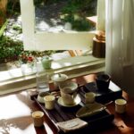 늘어나는 만성피로, 작은 습관 변화로 활력 찾기 Tea set arranged on a wooden tray by the window.