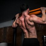 근육 관리, 바쁜 일상 속에서 실천하는 새로운 건강 트렌드 topless man in black shorts holding orange bar