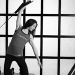 “집에서 쉽게 따라하는 필라테스, 건강한 일상 회복의 열쇠” woman in white tank top and black leggings doing yoga